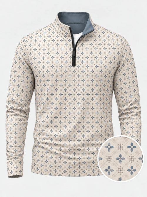 Cremefarbener Golfpullover aus Funktionsmaterial mit blauem Blumenmuster und kurzem Reißverschluss