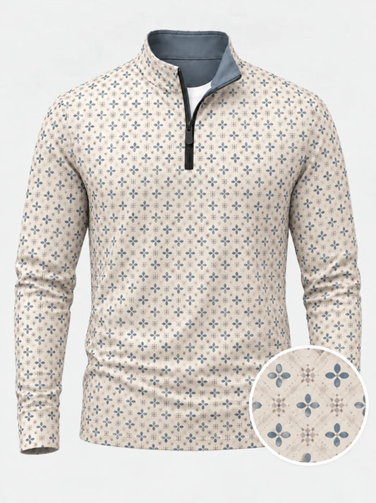 Cremefarbener Golfpullover aus Funktionsmaterial mit blauem Blumenmuster und kurzem Reißverschluss