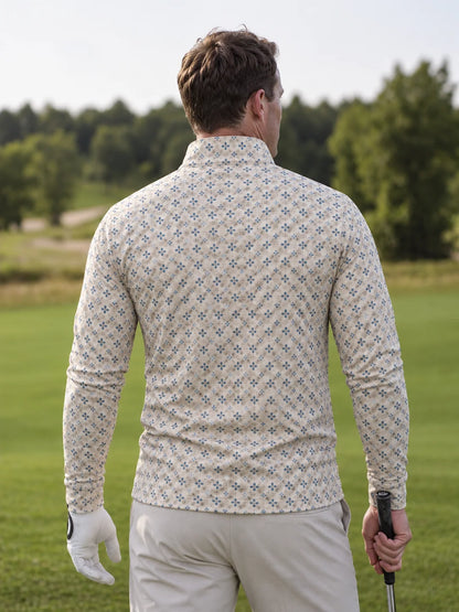 Cremefarbener Golfpullover aus Funktionsmaterial mit blauem Blumenmuster und kurzem Reißverschluss