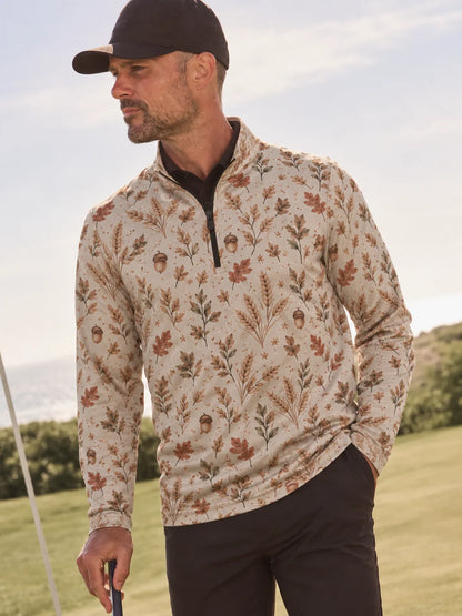 Cremefarbener Golfpullover aus Funktionsmaterial mit herbstlichem Blumenmuster und kurzem Reißverschluss